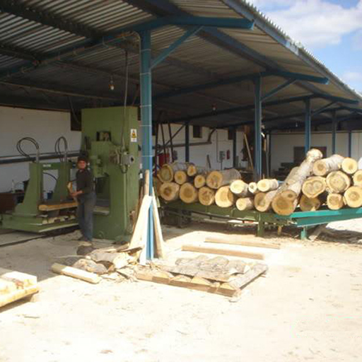 A forklift operator moving a stack of pallets in a warehouse.